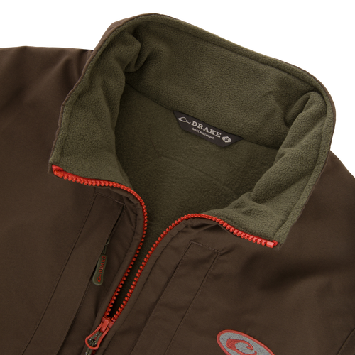 Close-up of the Drake Eqwader Vest, showcasing its waterproof upper body, fleece lower torso, and secure chest pockets for storing valuables.