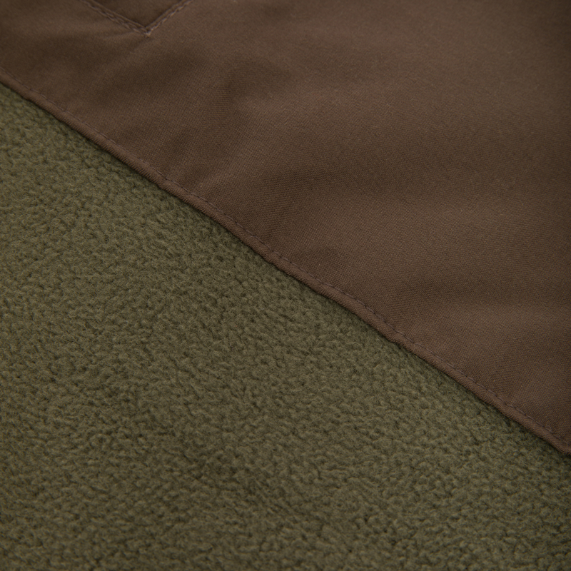 Close-up of the Drake Eqwader Vest, showcasing its waterproof upper with Magnattach™ pocket and breathable fleece lower, ideal for hunting versatility.