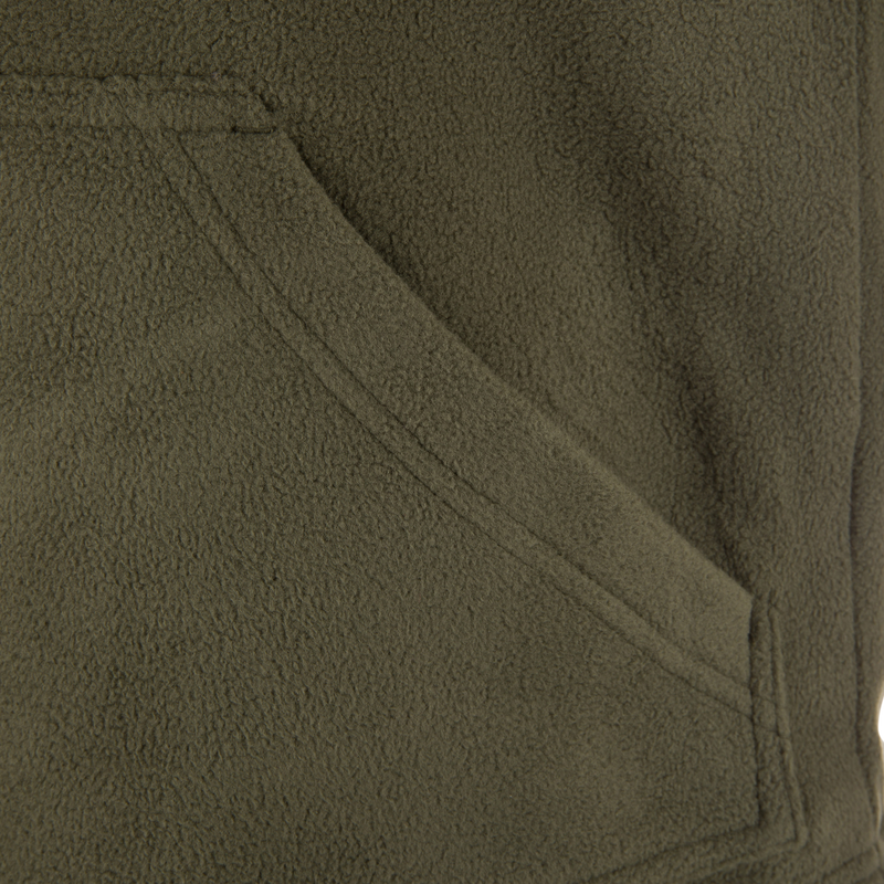Close-up of the Drake Eqwader Vest showcasing fleece fabric, vertical zippered chest pockets, and durable waterproof material designed for hunting and outdoor activities.