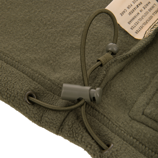 Eqwader Vest with close-up of button and green fleece, showcasing Magnattach™ chest pocket and waterproof Refuge HS™ upper body for versatile hunting functionality.