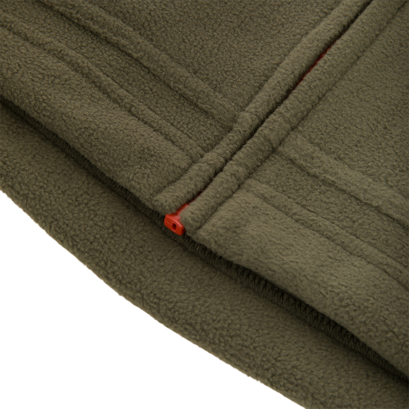 Close-up of the Drake Eqwader Vest highlighting its breathable polyester fleece and waterproof upper body, designed for enhanced mobility and secure storage with specialized chest pockets.