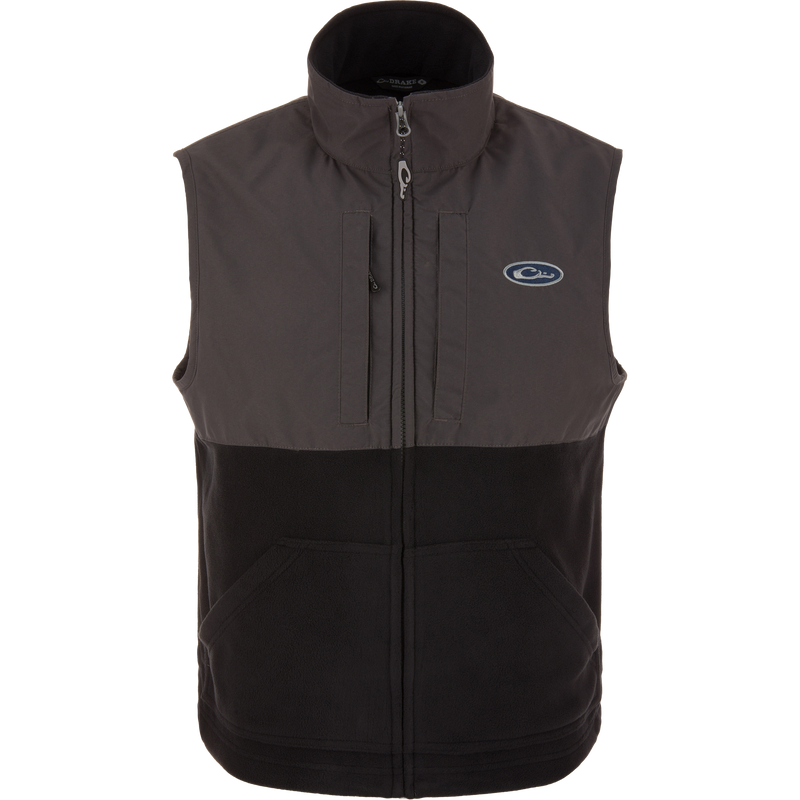 Eqwader Vest close-up showcasing mid-layer insulation, waterproof shoulders, breathable fleece lower torso, and secure chest pockets for valuables. Perfect for hunting and outdoor activities.