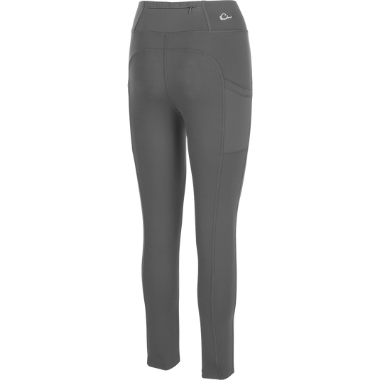 Women's Commando Solid Legging, a versatile high-performance legging with 4-way stretch fabric. Features include a 4-inch waistband, back zippered pocket, and angled side seam pockets. Quick drying and moisture-wicking for your next adventure.