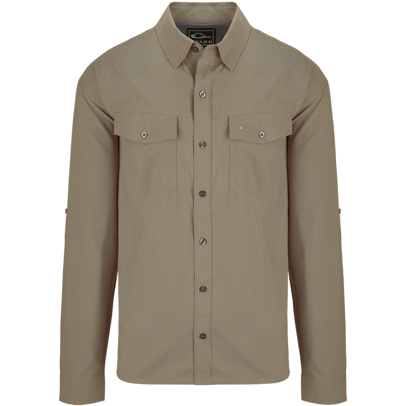 Traveler's Solid Dobby Shirt L/S: A classic fit, long-sleeved shirt with hidden button-down collar, chest pockets, and split tail hem. Made of featherweight, moisture-wicking fabric with UPF30 sun protection. Versatile for any occasion.