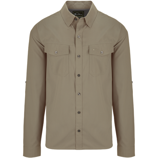 Traveler's Solid Dobby Shirt L/S: A classic fit, long-sleeved shirt with hidden button-down collar, chest pockets, and split tail hem. Made of featherweight, moisture-wicking fabric with UPF30 sun protection. Versatile for any occasion.