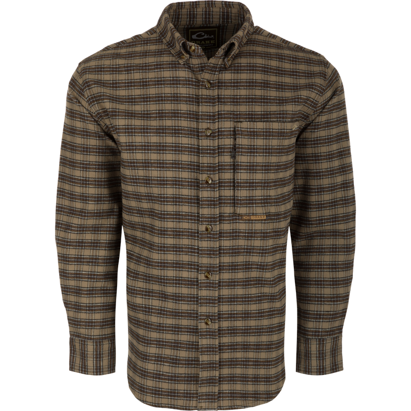 A brown plaid shirt with buttons, made from 100% brushed cotton twill. Features include a classic button-down collar, back box pleat with locker loop, and open and hidden zippered chest pockets. Perfect for a refined and sophisticated look.