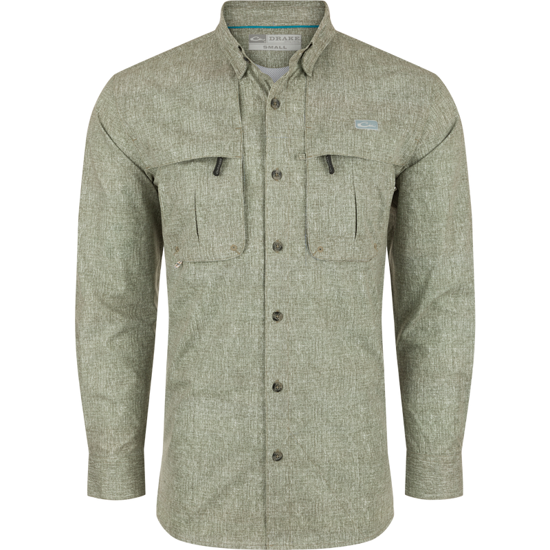 A Drake Heritage Heather Shirt L/S, a long-sleeved shirt with pockets. Made of 100% polyester micro mesh for natural cooling, moisture-wicking, and quick-drying. Features include a hidden button-down collar, vented cape back, and two front chest pockets. Perfect for performance on the water or at the office.