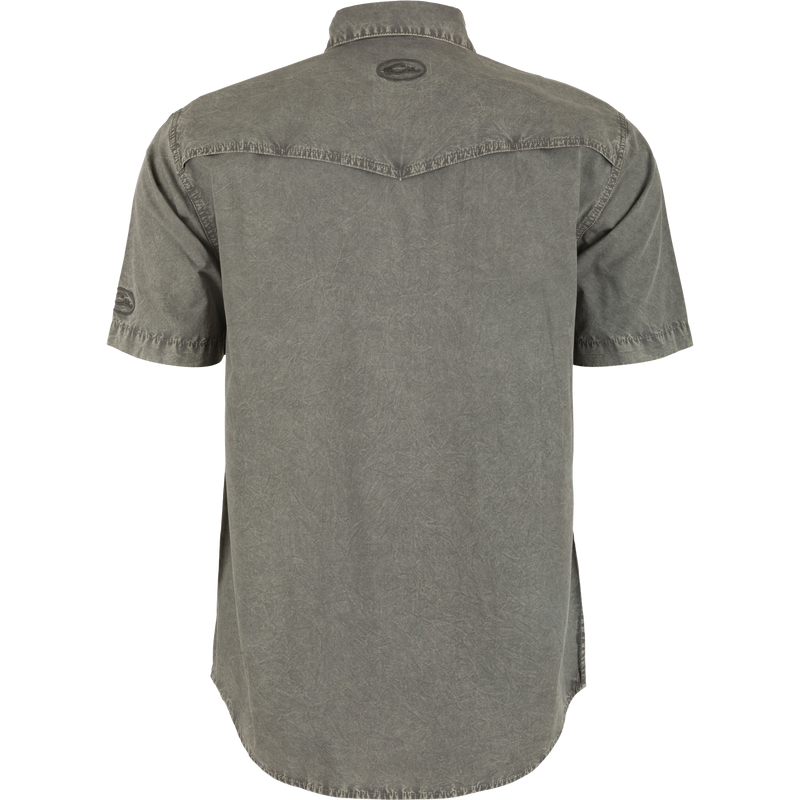 Back view of the Cinco Ranch Western Acid Washed Short Sleeve Shirt, highlighting its vented Western back cape and faux pearl snap buttons.