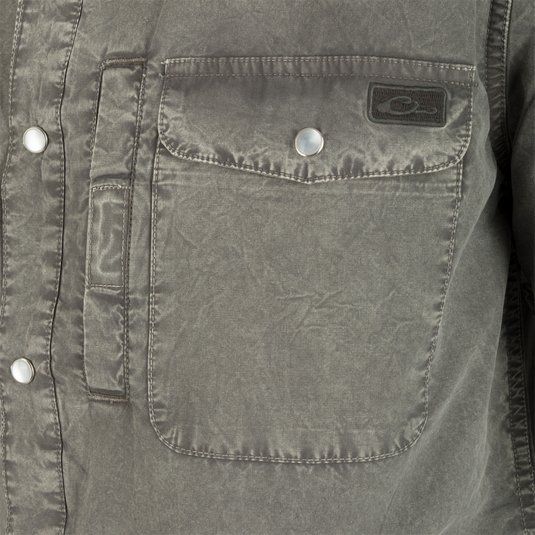 Close-up of the Cinco Ranch Western Acid Washed Short Sleeve Shirt highlighting the pocket, faux pearl snaps, and grey fabric texture.