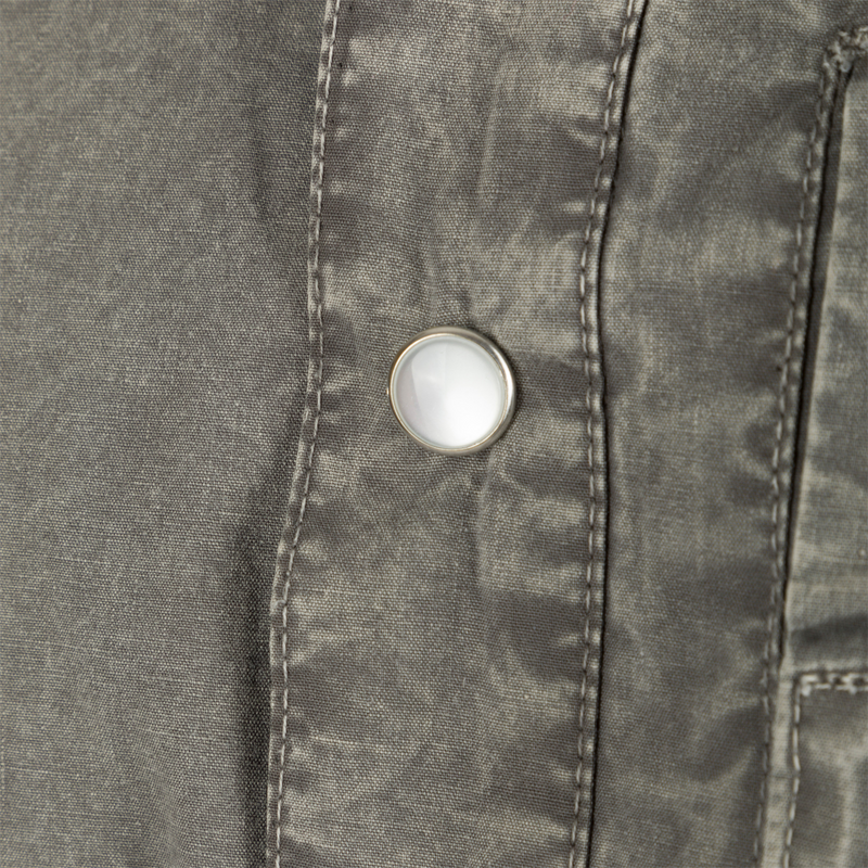 Close-up of the Cinco Ranch Western Acid Washed Cotton Shirt, highlighting a faux pearl snap and detailed stitching on the fabric, emphasizing Western design features.