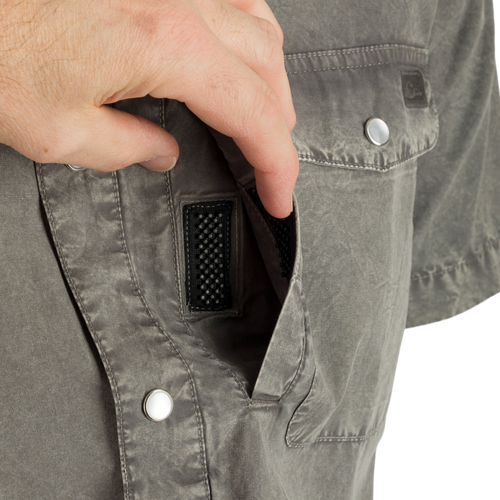 Cinco Ranch Western Acid Washed Short Sleeve Shirt with a hand demonstrating the Magnattach closure on the left chest pocket, highlighting the shirt's casual, functional design.