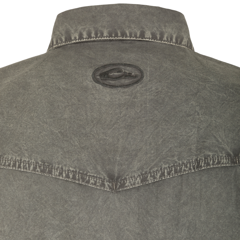 Cinco Ranch Western Acid Washed Short Sleeve Shirt with faux pearl snaps, vented back, and hidden button-down collar, highlighting its unique acid wash texture and Western style.
