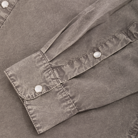 Close-up of the Cinco Ranch Western Solid Acid Wash Long Sleeve Shirt's cuff, showcasing the faux pearl snap buttons and stitched placket detail.