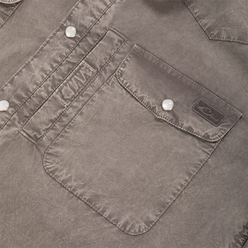 Close-up of Cinco Ranch Western Solid Acid Wash Long Sleeve Shirt showing flap pocket with pearl snap, brand label, and contrasting topstitching.