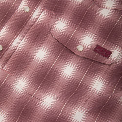 Close-up of the Drake Cinco Ranch Western Plaid Long Sleeve Shirt, highlighting its faux pearl snap button and plaid micro-mesh fabric designed for performance and comfort.