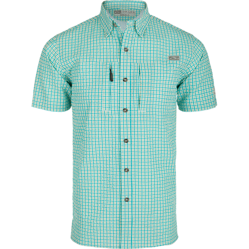 A Classic Seersucker Grid Check Shirt with a hidden button-down collar, zippered chest pocket, and Magnattach™ closure. Made from 76% Polyester and 24% Nylon, it offers UPF30 sun protection and moisture-wicking properties. Vented cape back and split tail hem provide ventilation and versatility. Perfect for hunting, fishing, or casual wear.