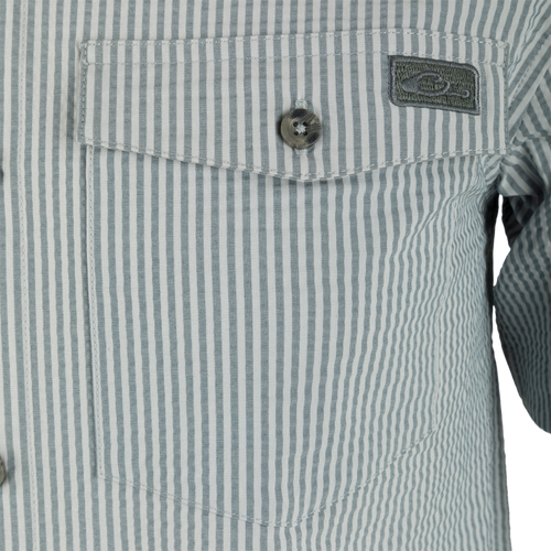 Close-up of the Frat Seersucker Striped Button-Down Short Sleeve Shirt, showcasing its vented cape back, hidden button-down collar, and button-through flap chest pocket.