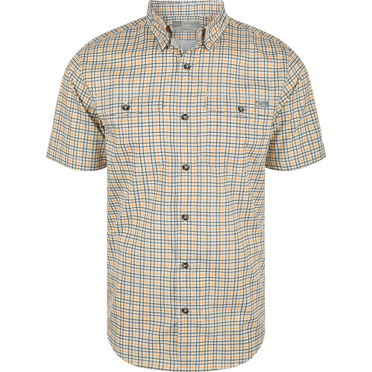 A white and orange plaid shirt with a hidden button-down collar, two button-through flap chest pockets, and a vented cape back. Made from lightweight performance fabric with UPF30 sun protection and moisture-wicking properties. Classic styling and technical features make the Frat Tattersall Shirt in a class of its own.