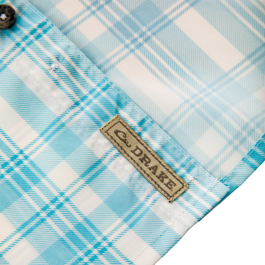 Frat Faded Plaid Button-Down Short Sleeve Shirt showcasing a blue and white plaid pattern, brown label, and stitched fabric details, ideal for active, outdoor wear.