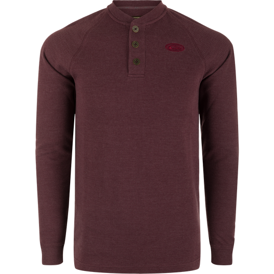 A Weston Lakes Waffle Long Sleeve Henley by Drake: Mélange fabric, raglan sleeves, metal logo buttons, rib knit collar and cuffs, split tail hem. Ideal for hunting and outdoor activities.