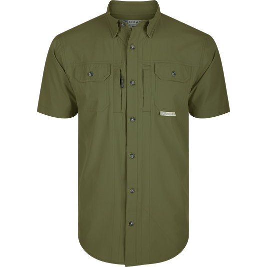 Wingshooter Trey Shirt S/S: Green shirt with buttons, hidden collar, flap pockets, vented back, and technical features for outdoor activities: Kalamata Olive