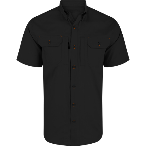 Wingshooter Trey Solid Short Sleeve Shirt featuring orange buttons, button-down collar, vented cape back, and dual flap chest pockets with hidden closures for versatile wear.