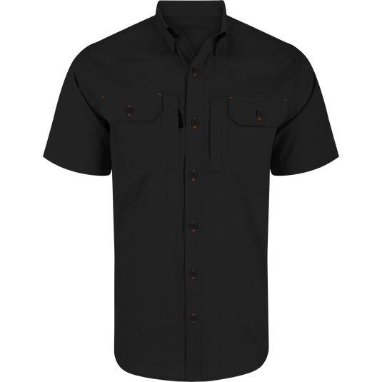 Wingshooter Trey Solid Short Sleeve Shirt featuring orange buttons, button-down collar, vented cape back, and dual flap chest pockets with hidden closures for versatile wear.