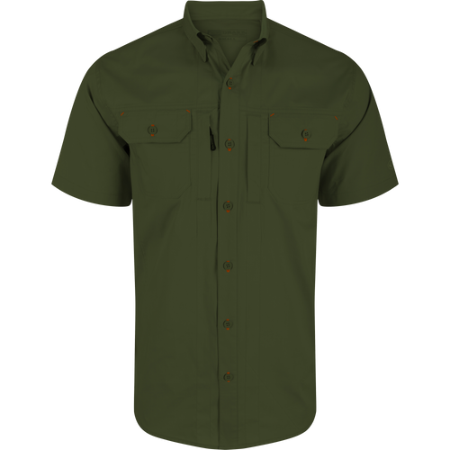 Wingshooter Trey Solid Short Sleeve Shirt featuring a soft cotton blend, button-through flap chest pockets, hidden button-down collar, and vented cape back for enhanced comfort and movement.