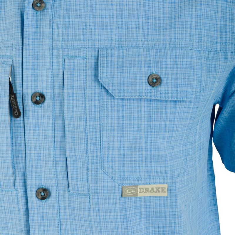 Wingshooter Trey Cross Hatch Short Sleeve Shirt with vented back, hidden button-down collar, and two chest pockets, showcasing premium performance features for outdoor activities.