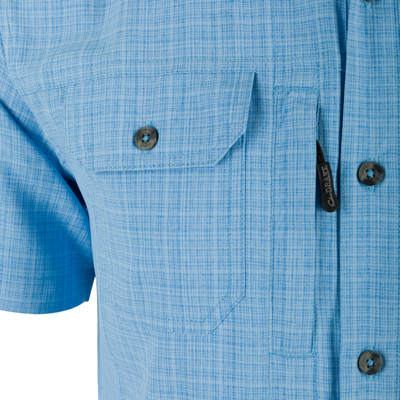 Wingshooter Trey Cross Hatch Short Sleeve Shirt with button-through flap chest pocket, hidden button-down collar, and vented cape back, highlighting performance fabric and technical features.