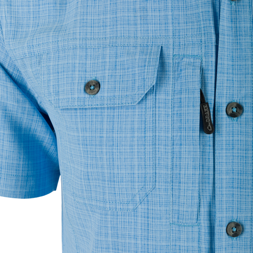 Wingshooter Trey Cross Hatch Short Sleeve Shirt with button-through flap chest pocket, hidden button-down collar, and vented cape back, highlighting performance fabric and technical features.