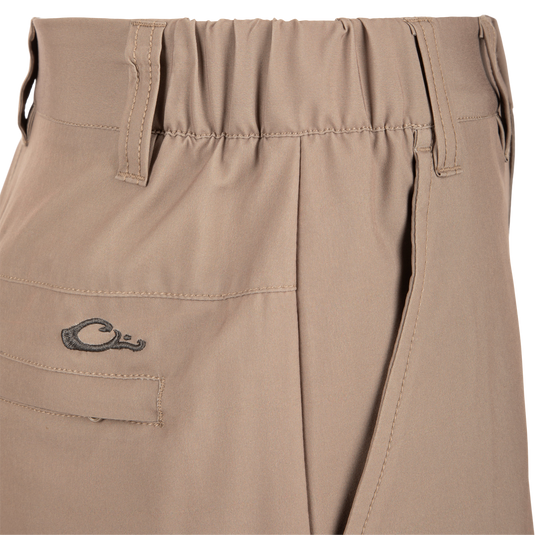 Close-up of Traveler Trek Short fabric with built-in stretch, moisture-wicking, and quick-drying features. Includes pockets and elastic waistband for comfort and functionality.