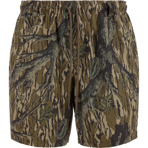 Dock Short 6: duck camo swim trunks with elastic waistband, external drawstring, and multiple pockets, designed for durability and quick-drying performance.