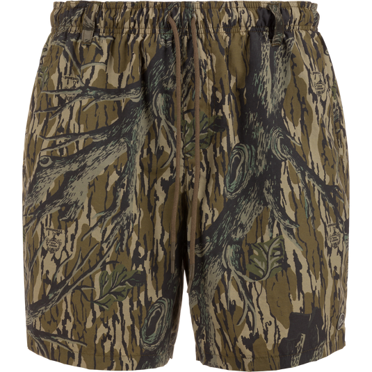 Dock Short 6: duck camo swim trunks with elastic waistband, external drawstring, and multiple pockets, designed for durability and quick-drying performance.