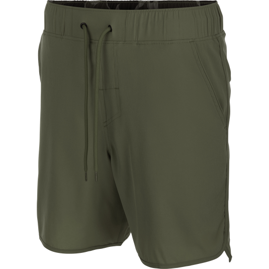 Commando Lined Volley Short 7in, featuring a scalloped hem, back zippered pockets, and an elastic waistband with drawstring, ideal for versatile, active wear.