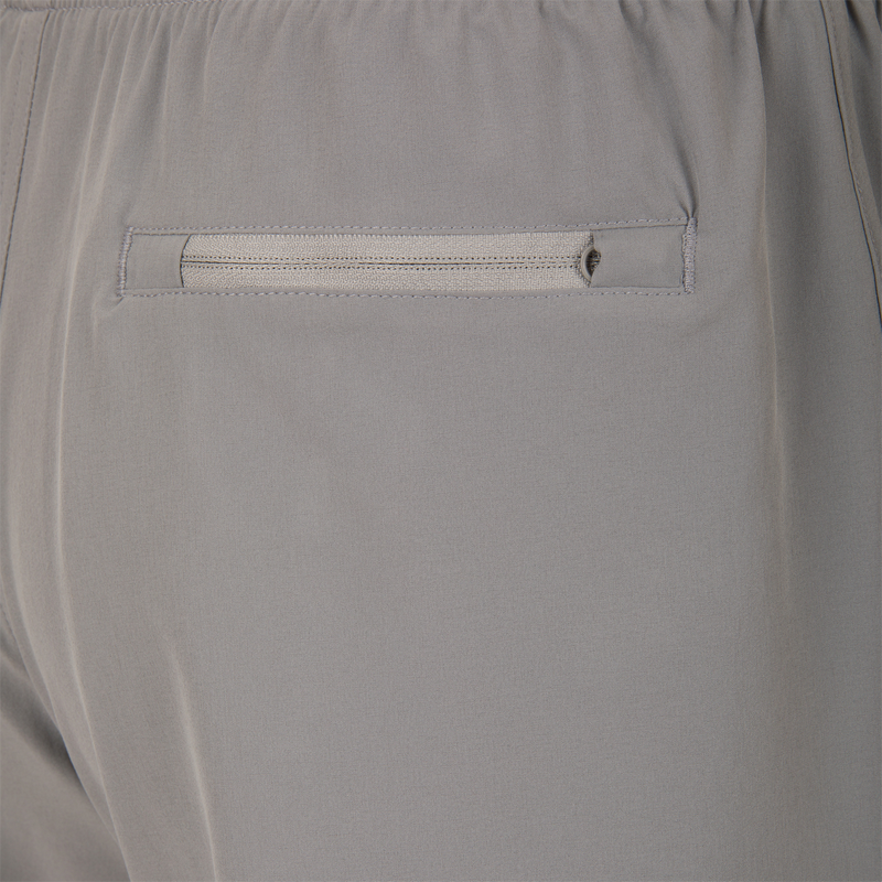 Drake Commando Lined Volley Short 7 with built-in liner, adjustable waistband, and moisture-wicking fabric, featuring front and back pockets with zippers.