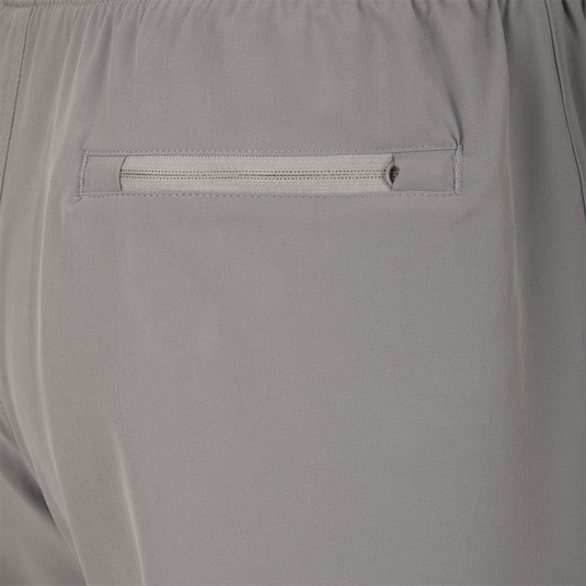 Drake Commando Lined Volley Short 7 with built-in liner, adjustable waistband, and moisture-wicking fabric, featuring front and back pockets with zippers.