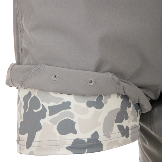 Drake Commando Lined Volley Short 7 showcasing elastic waistband, drawstring, scalloped hem, and zippered back pockets. Designed with quick-dry and moisture-wicking features.