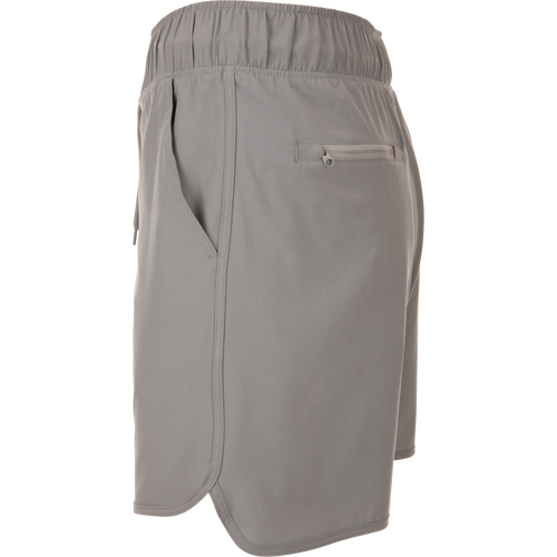 Commando Lined Volley Short 7in with built-in liner, elastic waistband, adjustable drawstring, scalloped hem, and zippered back pockets, ideal for versatile outdoor activities.