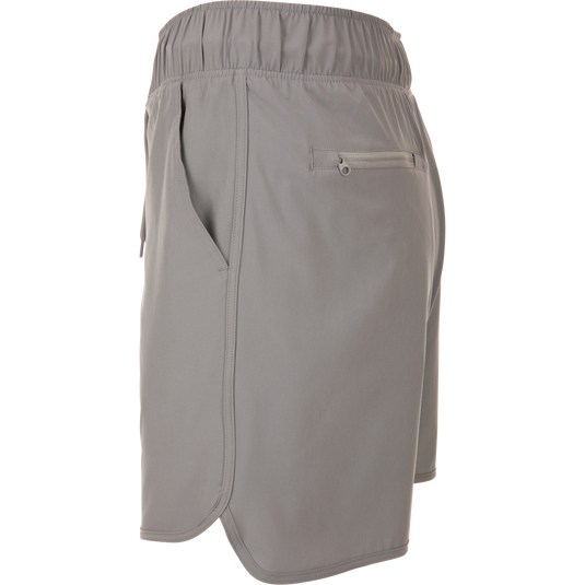 Commando Lined Volley Short 7in with built-in liner, elastic waistband, adjustable drawstring, scalloped hem, and zippered back pockets, ideal for versatile outdoor activities.