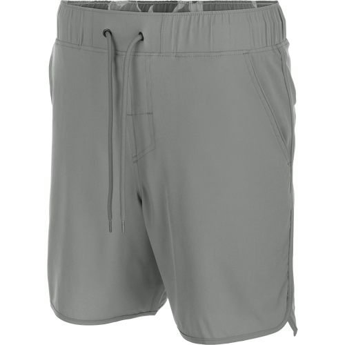Commando Lined Volley Short 7in with elastic waistband, adjustable drawstring, scalloped hem, built-in liner, and hidden zippered pockets, ideal for versatile outdoor activities.