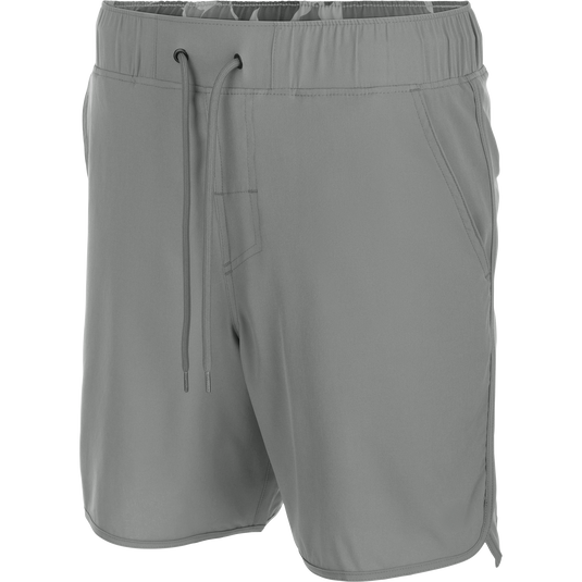 Commando Lined Volley Short 7in with elastic waistband, adjustable drawstring, scalloped hem, built-in liner, and hidden zippered pockets, ideal for versatile outdoor activities.