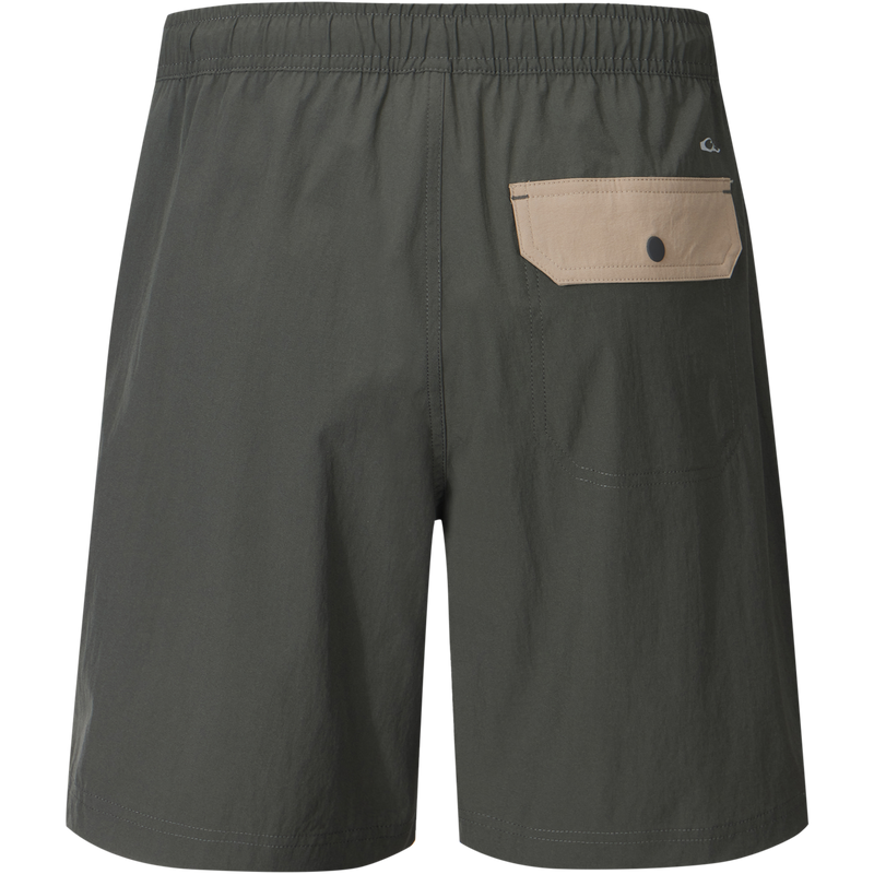 Spring Brake Short featuring an elastic waistband, zippered pocket, and lightweight fabric with stretch, designed for versatile comfort and performance in various activities.