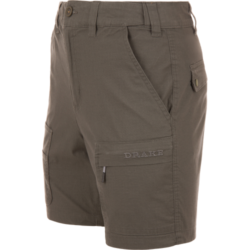 Olive-green 9 Pocket Ripstop Short on mannequin, featuring multiple pockets, including zip and flap, with elastic waistband, ideal for outdoor adventures.