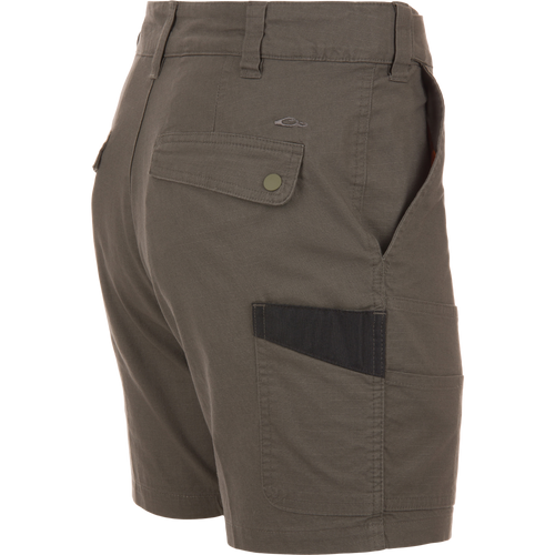 Back and side view of olive-green 9 Pocket Ripstop Short on mannequin, featuring snap-flap back pocket, side pocket with darker insert, and self-adjusting waistband.