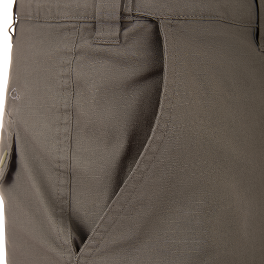 Front pocket view of the Drake 9 Pocket Ripstop Short, showcasing stitching, waistband belt loop, and durable design for versatile outdoor adventures.