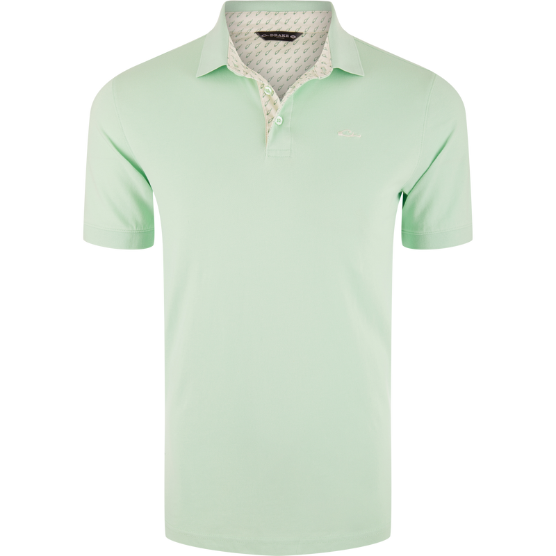 Pique Logo Polo featuring a white collar, three-button placket, rib knit cuffs, and embroidered Drake duck logo on chest, showcasing classic style with modern stretch.