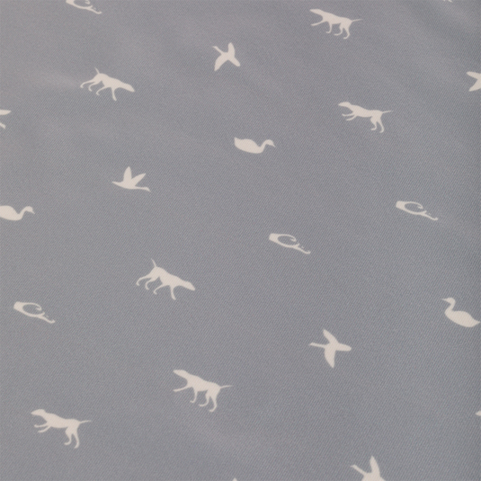 Performance Print Polo Shirt with grey fabric featuring white animals like dogs and birds. Equipped with a self-fabric collar, open cuffs, and split hem.