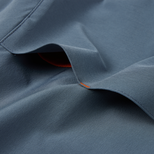 Close-up of the Lake Shore Performance Short Sleeve Shirt showcasing its lightweight, moisture-wicking fabric and technical design features like vented cape back and chest pockets.