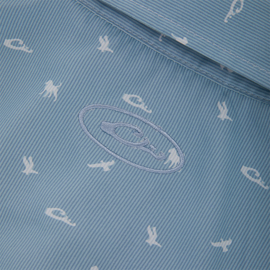 Close-up of Drake Cinco Ranch Western Short Sleeve Shirt's pale blue lining with white nautical prints and embroidered brand logo.